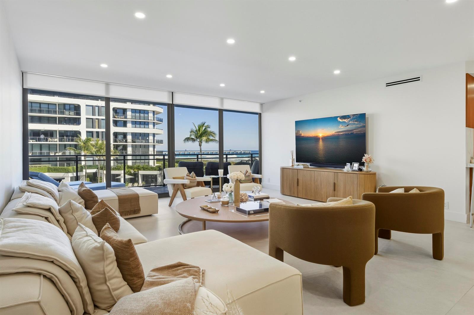 A modern living room features a large sectional, two armchairs, and floor-to-ceiling windows overlooking the ocean — 3100 S Ocean Boulevard # 201s, Palm Beach FL 33480, PALM BEACH, FL