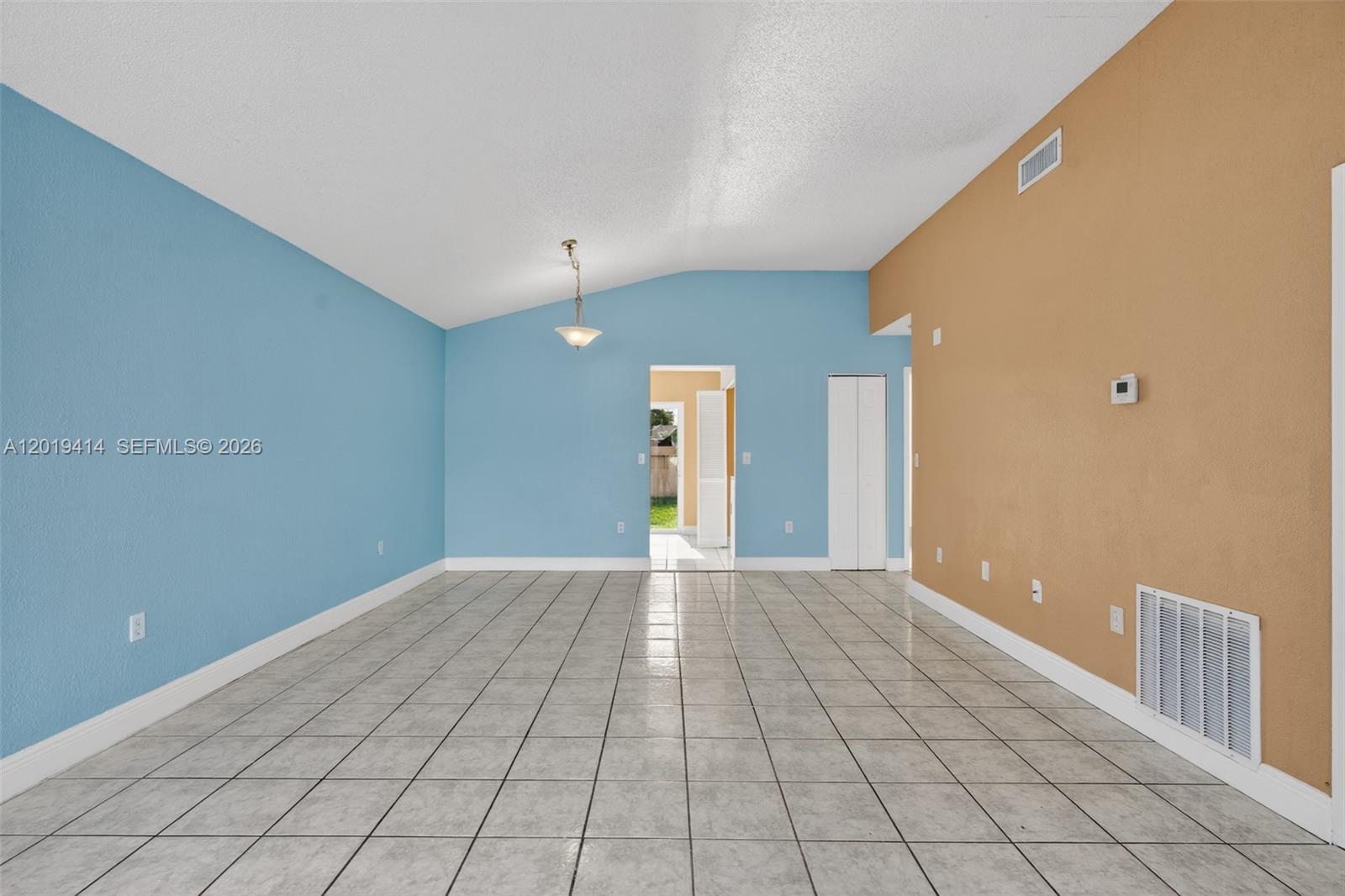 A room with light blue and tan walls, tile flooring, and a vaulted ceiling — 20841 SW 103rd Ct, Cutler Bay FL 33189, CUTLER BAY, FL