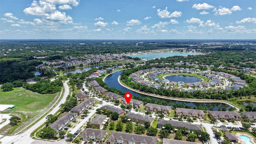 An aerial view shows a residential neighborhood with a red location pin on a townhouse — 6710 HOLLY HEATH DRIVE, RIVERVIEW, FL