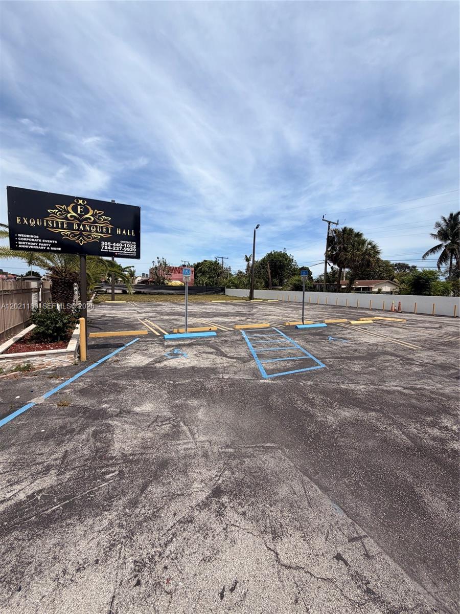 An outdoor parking lot features a sign for Exquisite Banquet Hall and marked handicap spaces — 920 NW 119th St, Miami FL 33168, MIAMI, FL