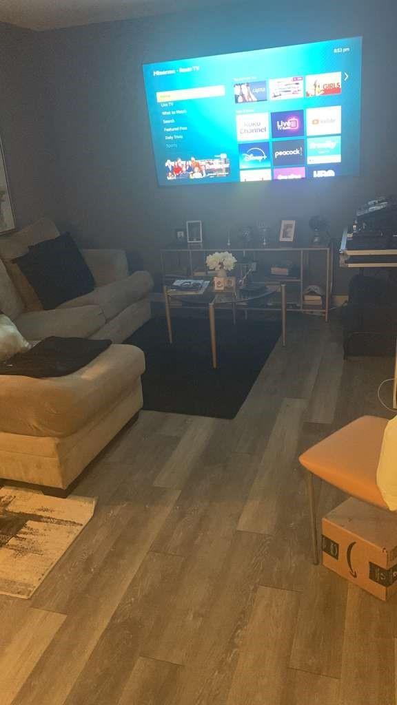 A living room features a wall-mounted television, a beige sofa, and wood-look flooring — 1333 S Dixie Highway # 202, Deerfield Beach FL 33441, DEERFIELD BEACH, FL