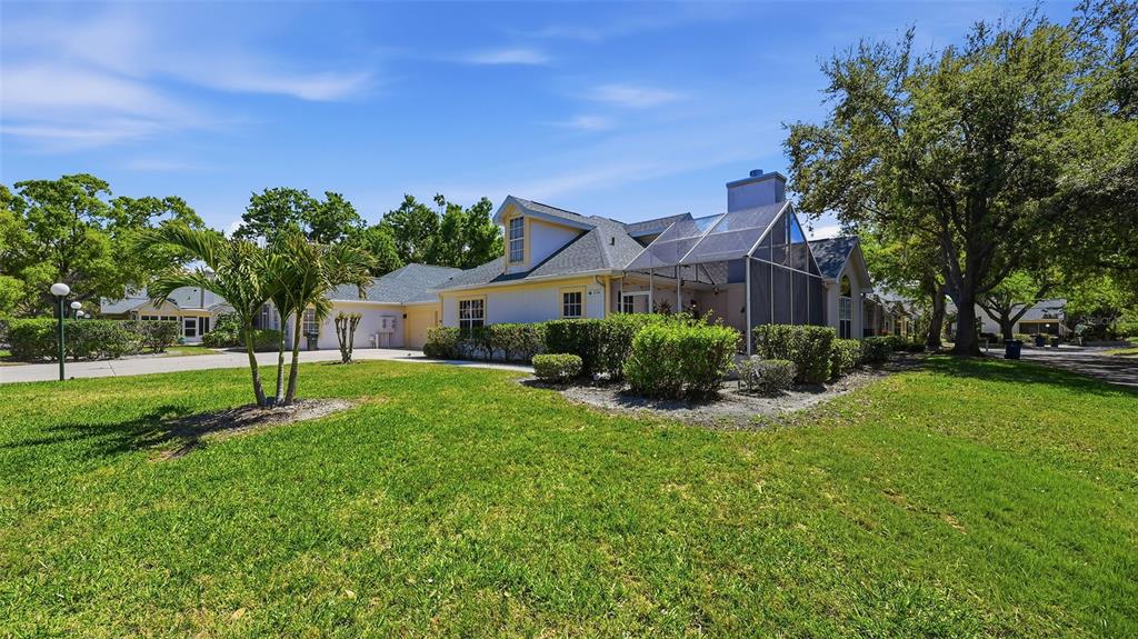A single-story house with a two-car garage, a dormer window, and a front lawn — 4504 CITATION LANE UNIT C, SARASOTA, FL