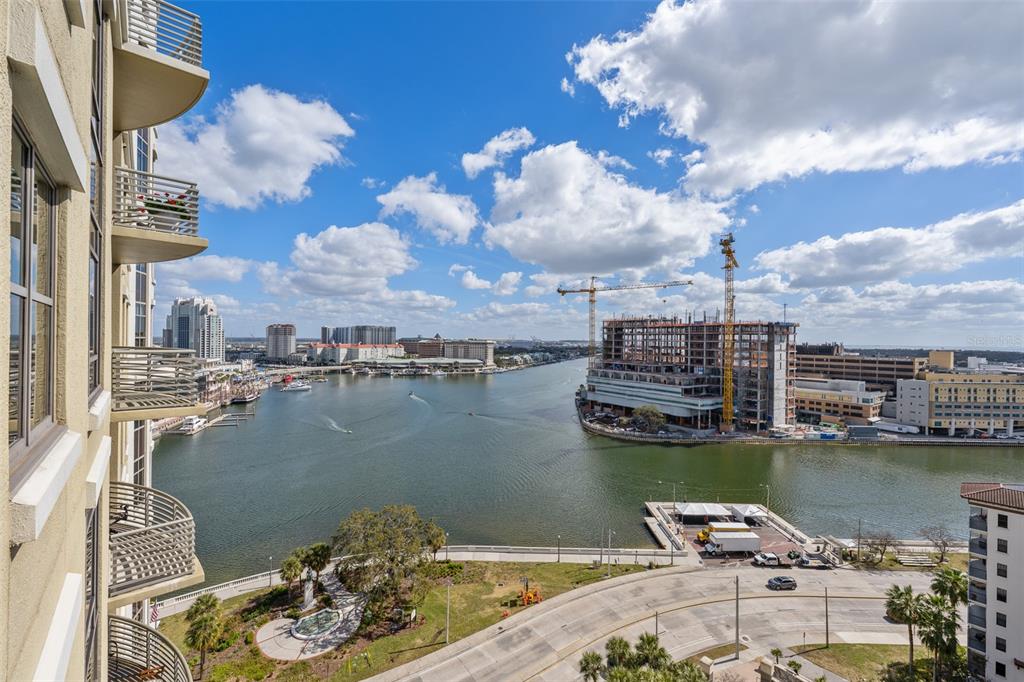 An elevated view shows a waterfront cityscape with a large building under construction and cranes — 275 BAYSHORE BOULEVARD UNIT 1507, TAMPA, FL