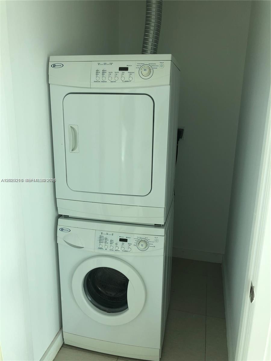 A stacked Maytag washer and dryer unit is installed in a small laundry closet — 3301 NE 1 AVE # H1003, Miami FL 33137, MIAMI, FL