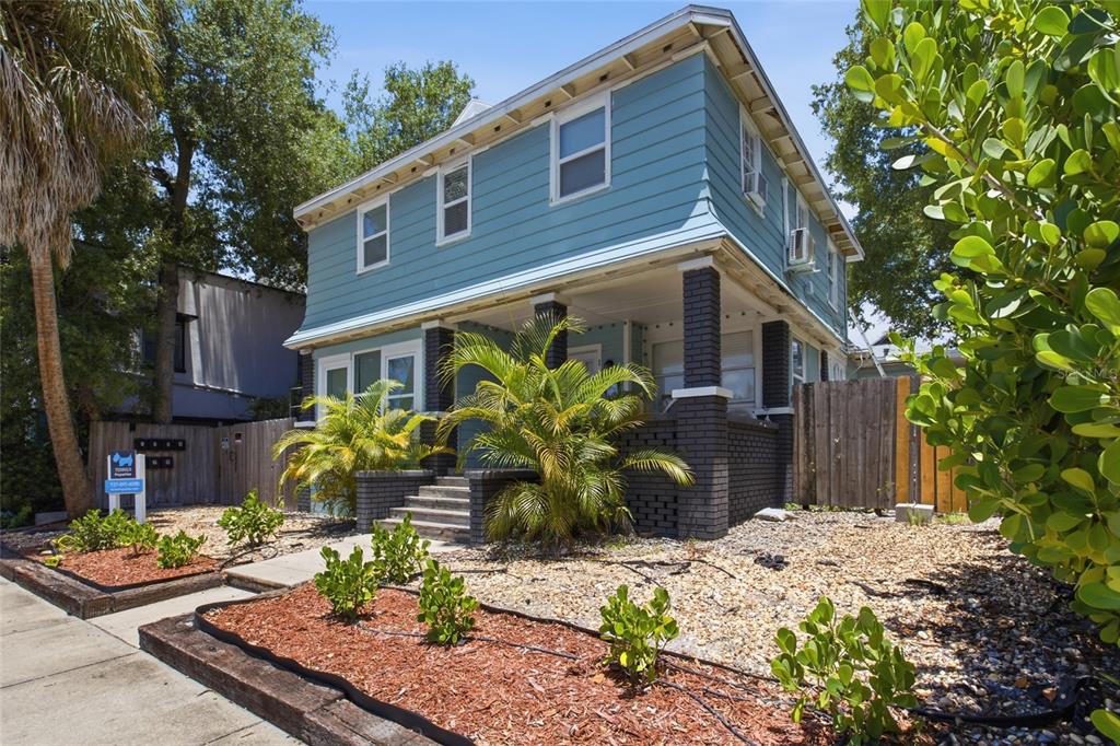 A two-story blue house with a brick porch and palm trees in the front yard — 335 5TH AVENUE N, ST PETERSBURG, FL