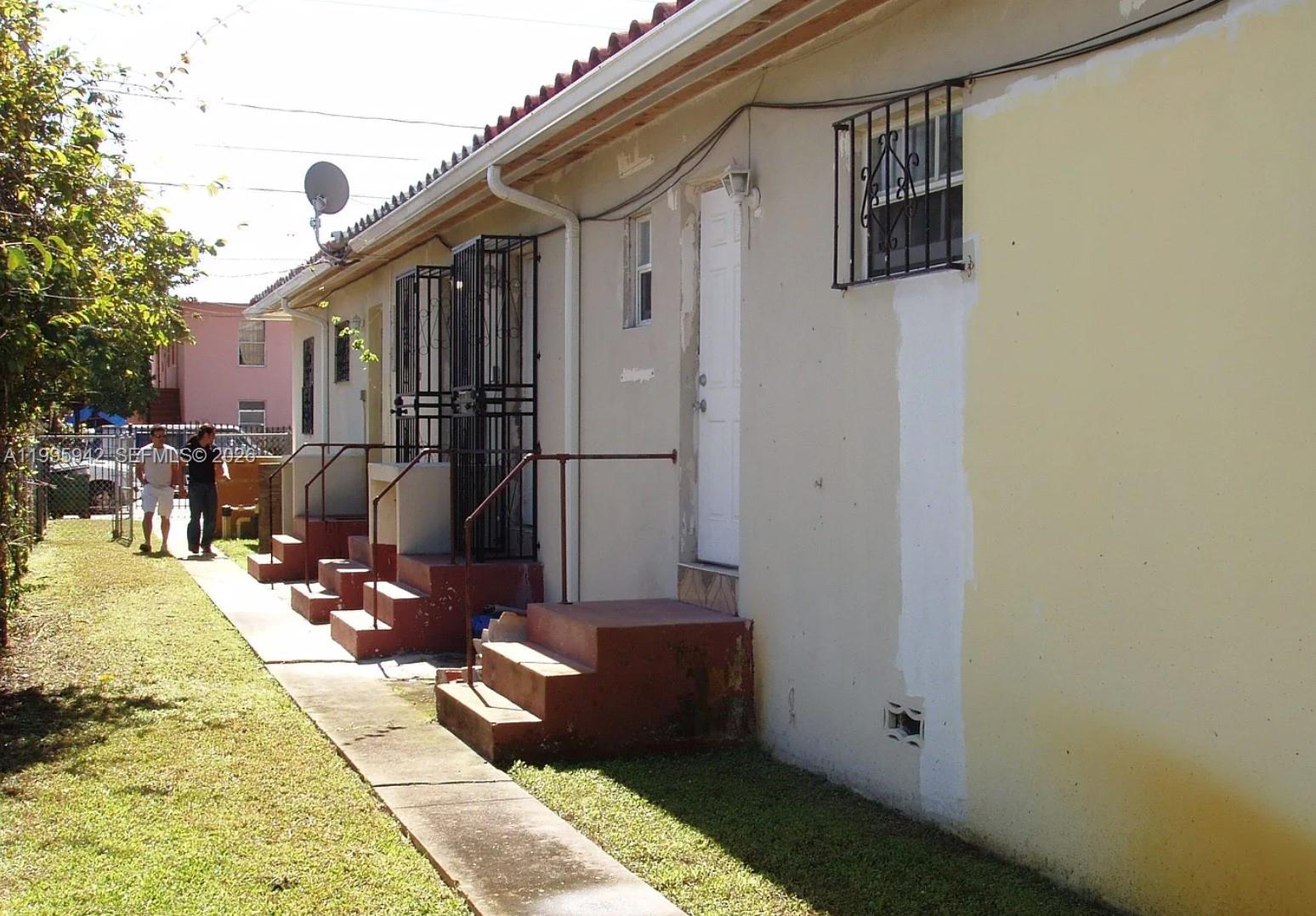 The exterior of a multi-unit building features concrete stairs, metal security bars, and a walkway — 1325 SW 6th St, Miami FL 33135, MIAMI, FL