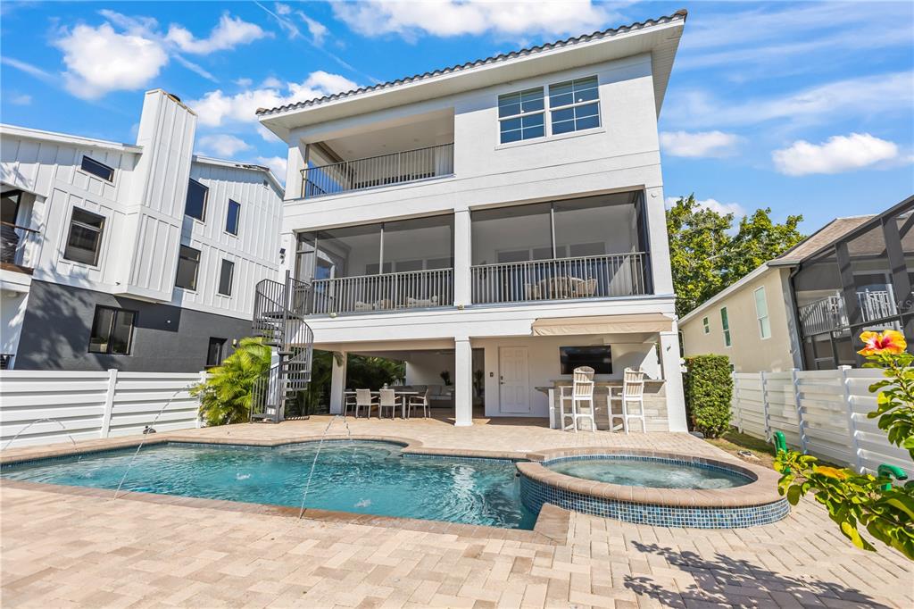 A three-story house features a swimming pool, hot tub, and a spiral staircase in back — 8008 MIDNIGHT PASS ROAD, SARASOTA, FL