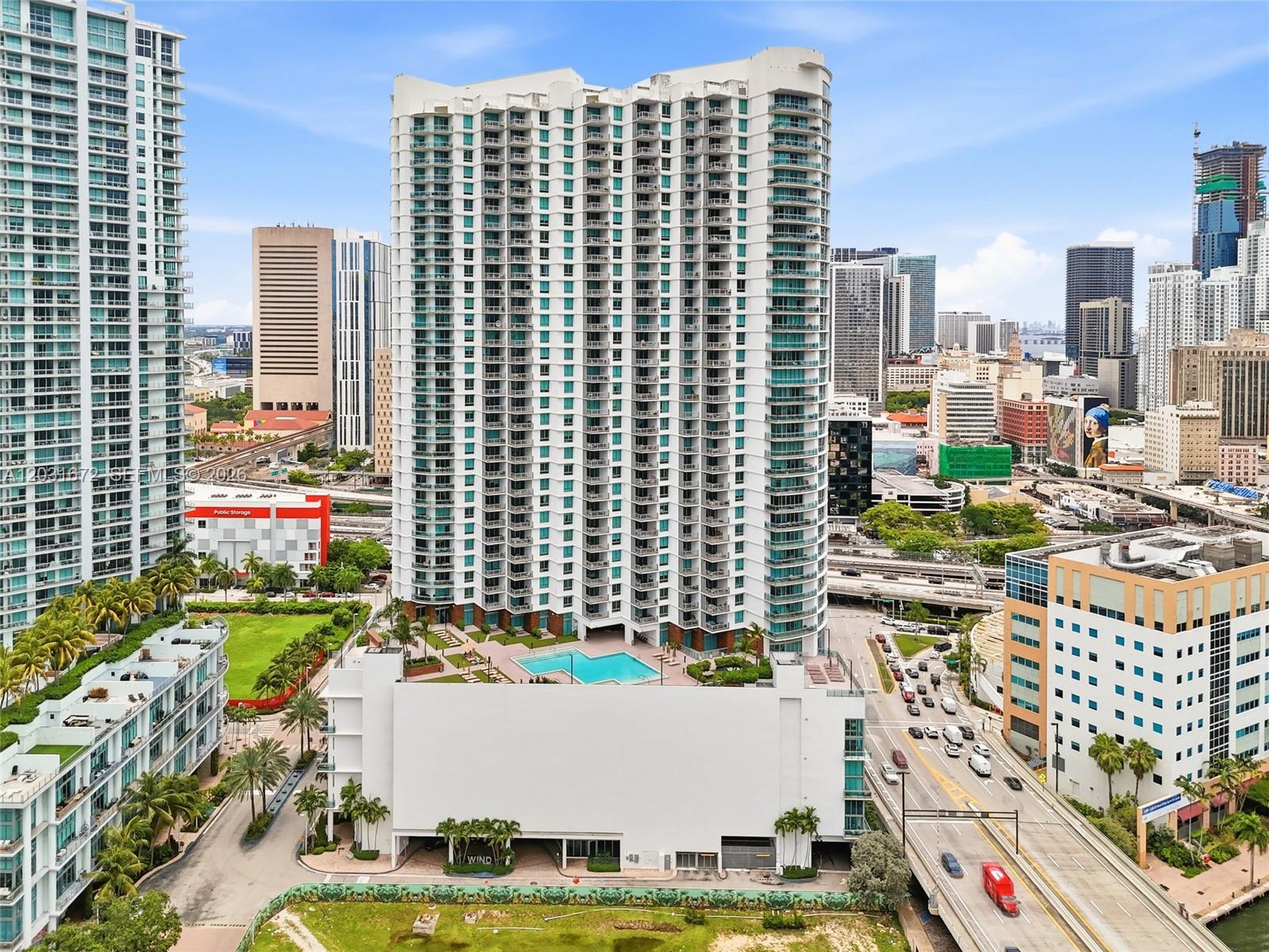 An aerial view of a tall residential high-rise building with an outdoor pool deck — 350 S Miami Ave # 3912, Miami FL 33130, MIAMI, FL