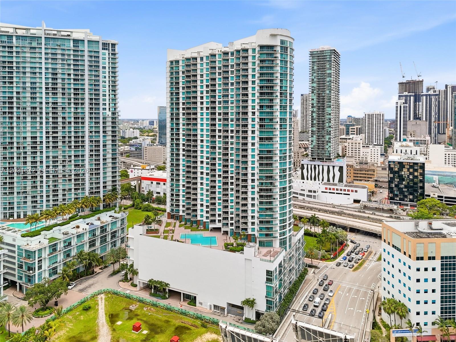 An aerial view of a tall residential high-rise building with an outdoor pool deck — 350 S Miami Ave # 3912, Miami FL 33130, MIAMI, FL
