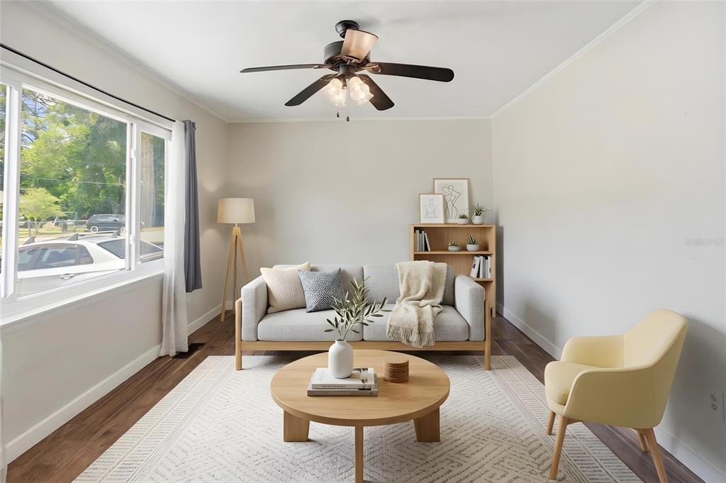 A living room features a light gray sofa, wooden coffee table, and a yellow armchair — 100 N HIGHLAND AVENUE, GREEN COVE SPRINGS, FL
