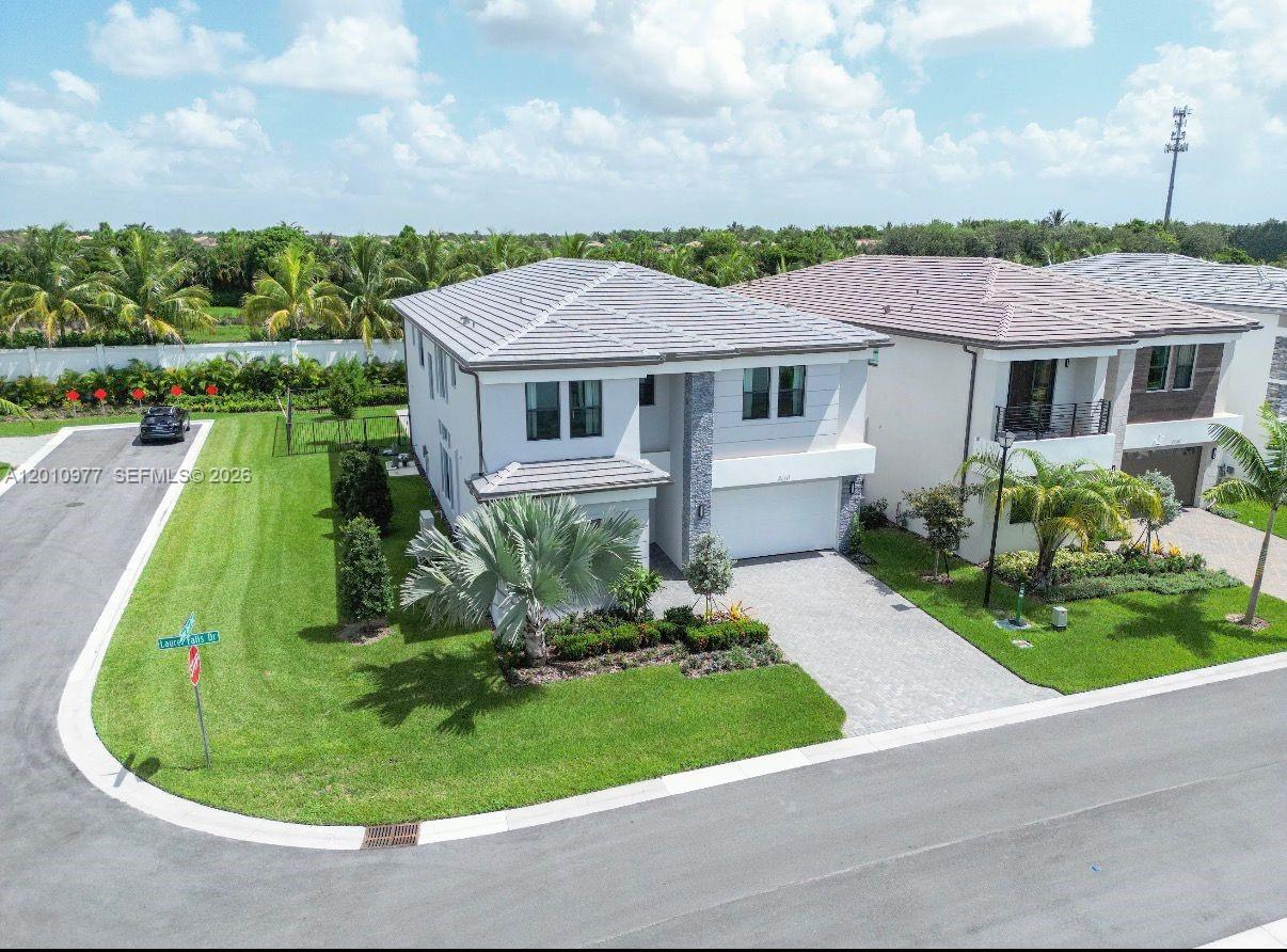 An aerial view shows a two-story suburban house with a paved driveway and lawn — 8151 Laurel Falls Dr, Boca Raton FL 33496, BOCA RATON, FL