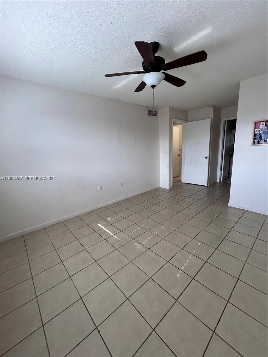 A room with white walls, a ceiling fan, and light-colored tile flooring — 15630 SW 80th St # 305, Miami FL 33193, MIAMI, FL