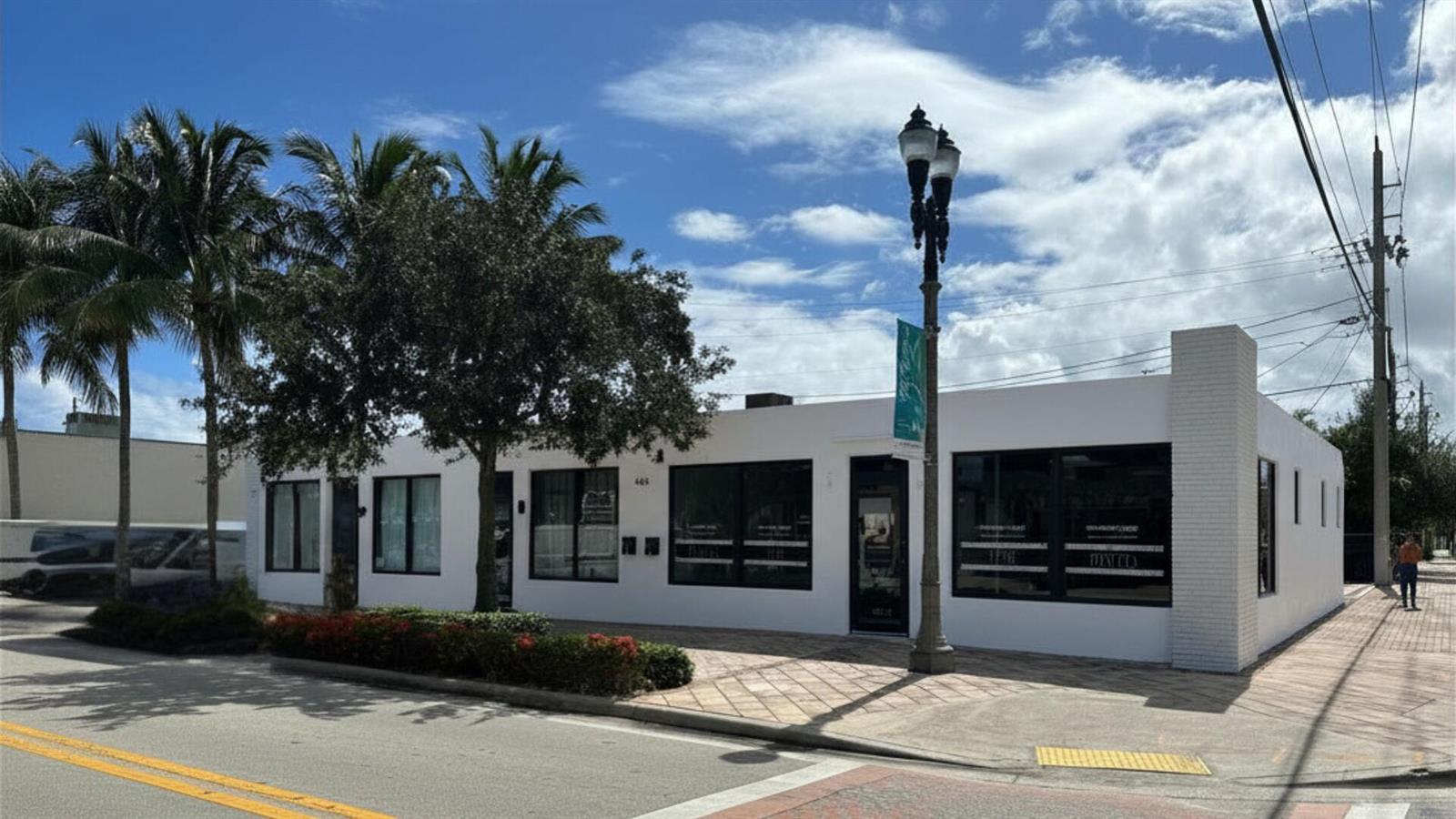 A white, single-story commercial building with large windows sits on a corner lot — 444 25th # 3, West Palm Beach FL 33407, WEST PALM BEACH, FL