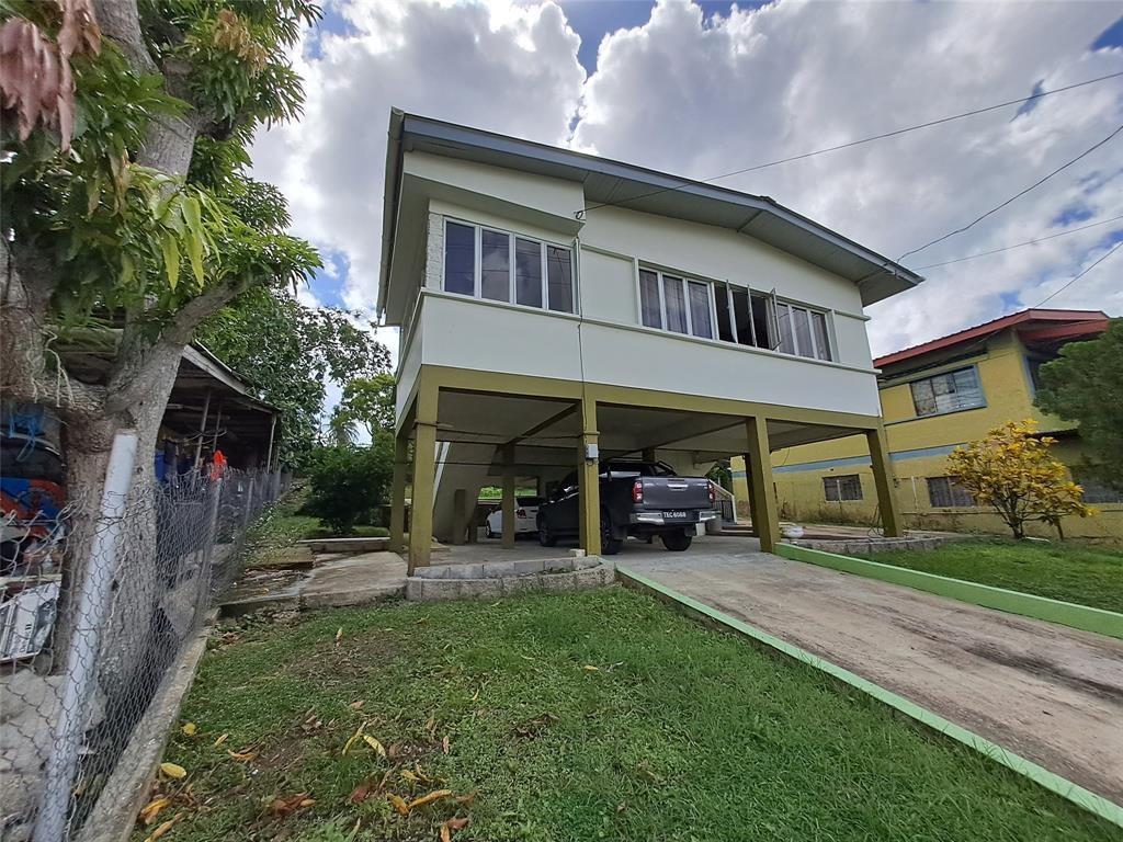 A two-story house with an elevated living area and a covered ground-level parking space — 21 Southern Main Road Duncan Village, FL