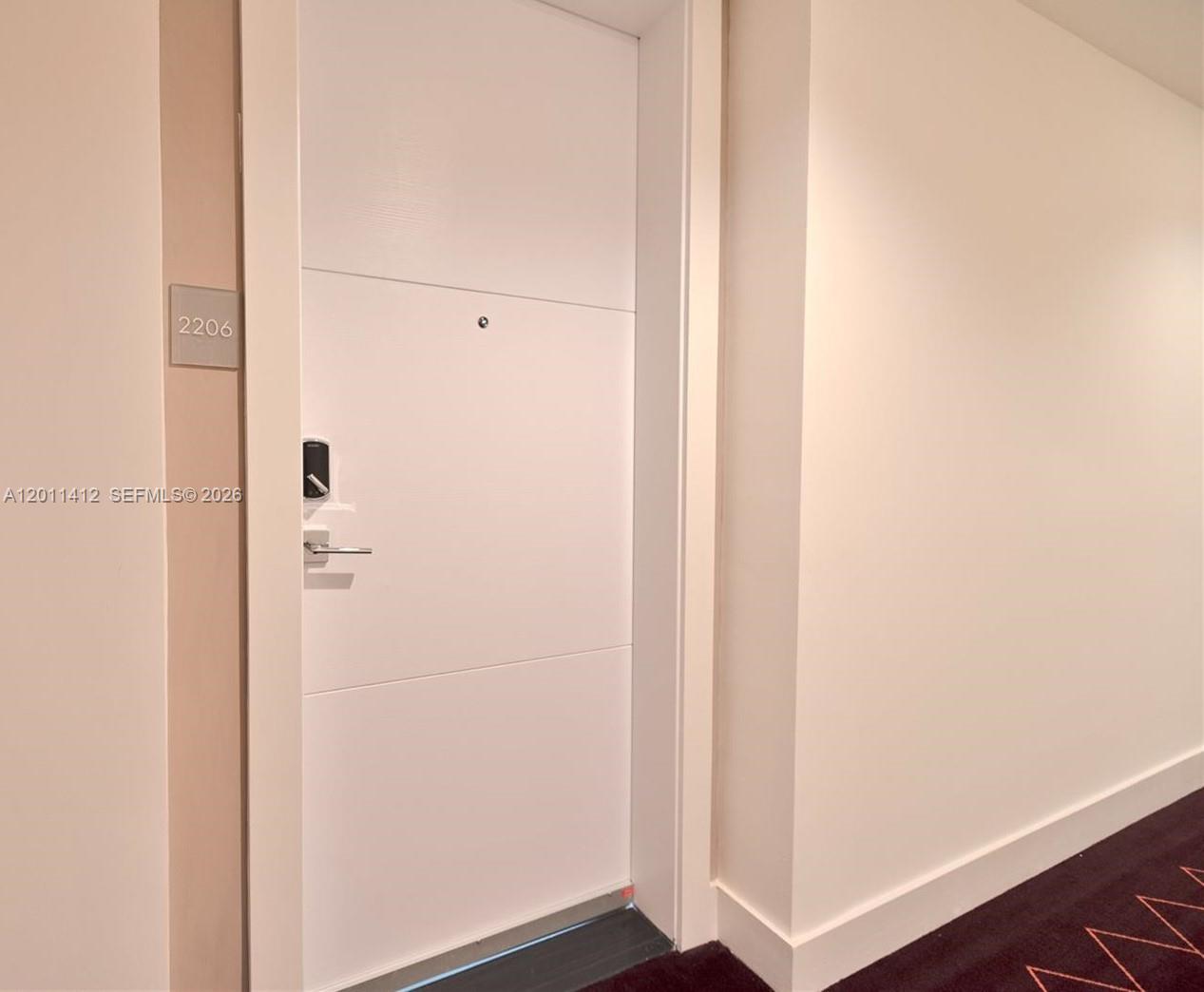 A white apartment door with a digital lock and a room number sign — 2000 Metropica Way # 2206, Sunrise FL 33323, SUNRISE, FL