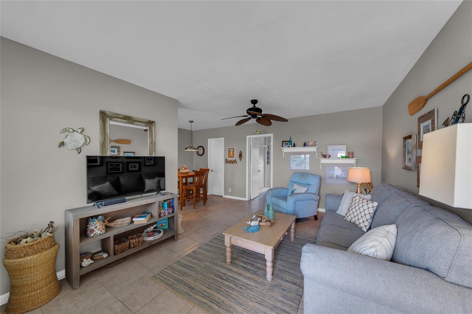 A living room features a grey sofa, a light wood coffee table, and a television console — 11 SW 4th Avenue # 11, Boca Raton FL 33432, BOCA RATON, FL