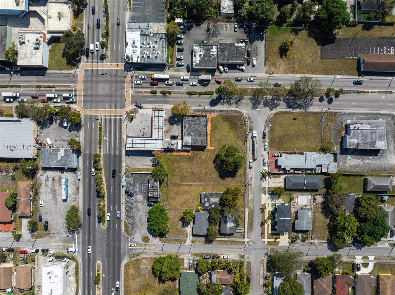 This aerial view shows a commercial intersection with surrounding buildings, parking lots, and vacant land — 6210 NW 22nd Ave, Miami FL 33147, MIAMI, FL