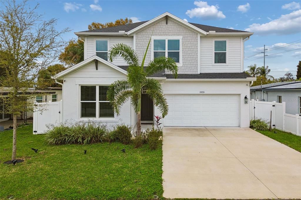 A two-story house with white siding, a palm tree, and a concrete driveway — 3920 W LEMON STREET, TAMPA, FL
