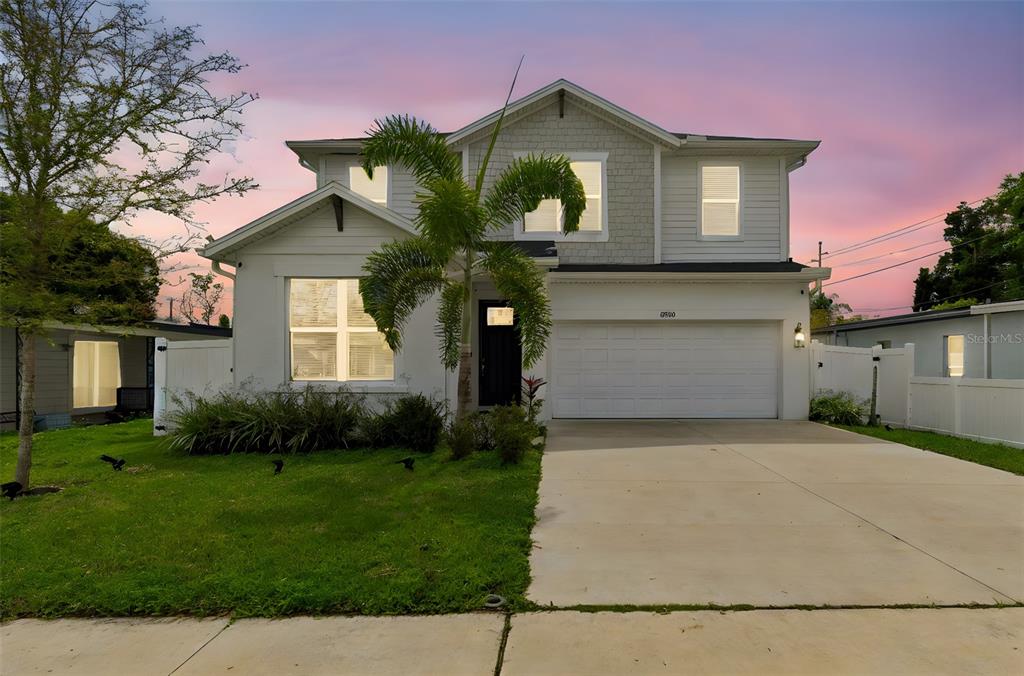 A two-story house with a white exterior, a palm tree, and a concrete driveway — 3920 W LEMON STREET, TAMPA, FL