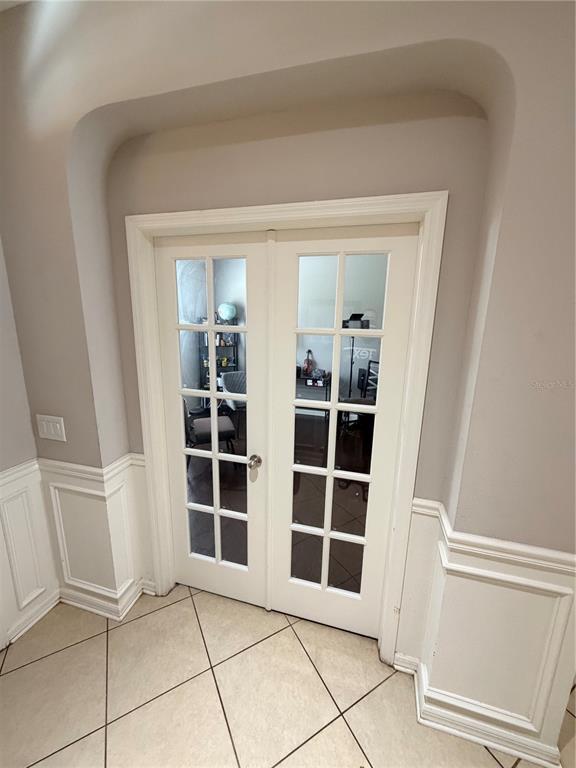 White French doors with glass panes are set within an arched wall opening — 2514 CROSS MORE STREET, VALRICO, FL