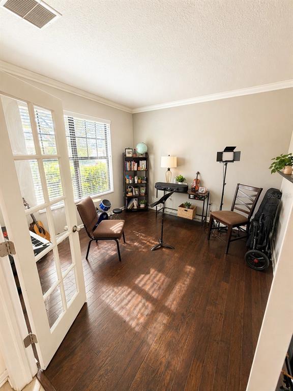 A music room features dark hardwood floors, a bookshelf, a desk, and musical instruments — 2514 CROSS MORE STREET, VALRICO, FL