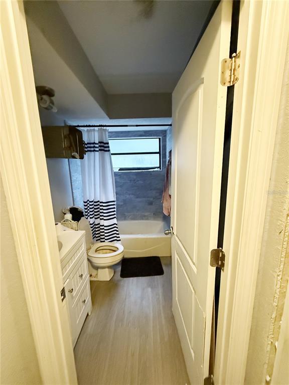 A bathroom features a white vanity, a toilet, and a tub with a shower curtain — 1521 W SAINT ELIZABETH PLACE, CITRUS SPRINGS, FL