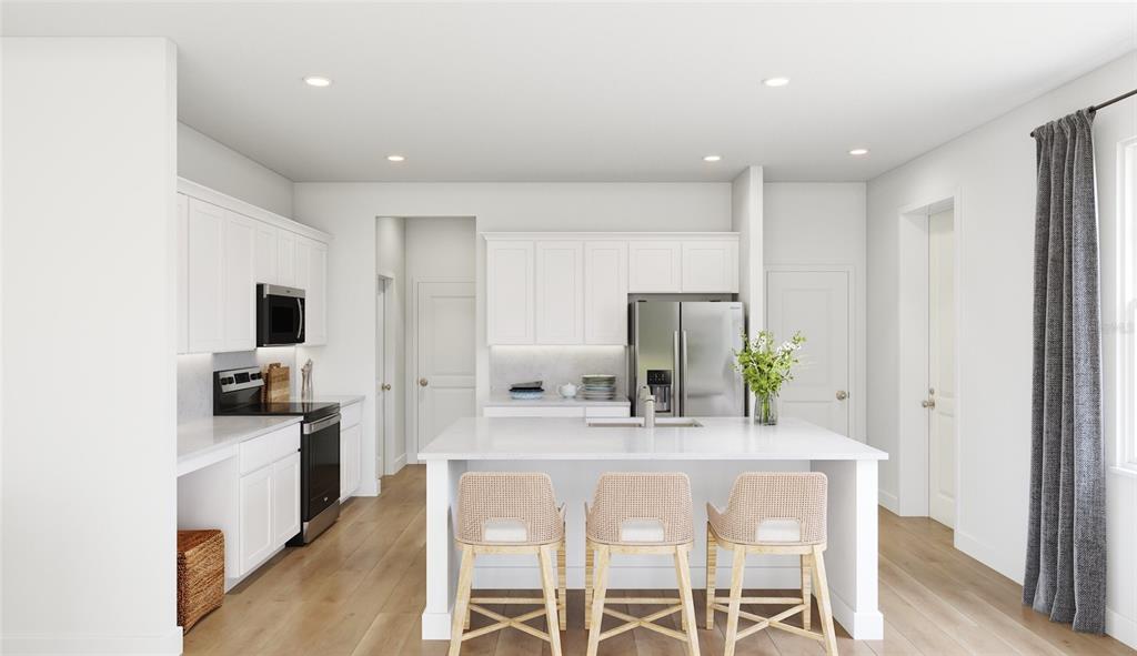 This is a rendering of a modern kitchen featuring white cabinetry and a central island — 10040 BLACKSTONE CREEK COURT Aster, RIVERVIEW, FL