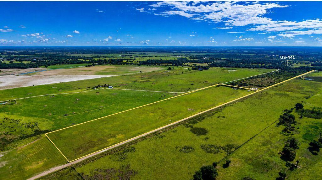 An aerial view shows a large, rectangular plot of green land outlined in yellow — Tbd Kenansville Road, FL 34739, FL