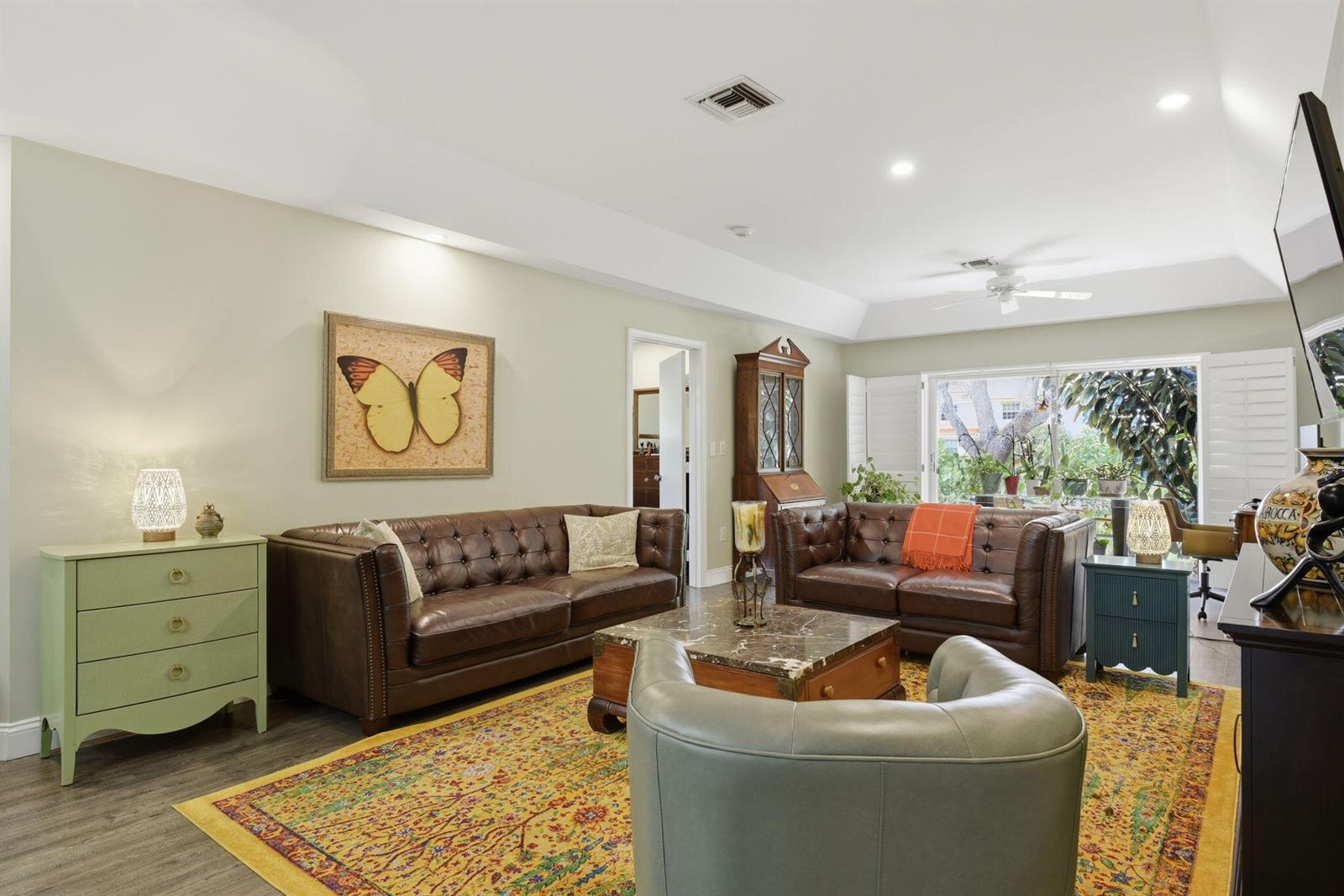 A living room features two brown leather sofas, a marble coffee table, and a yellow rug — 9857 Summerbrook Terrace # B, Boynton Beach FL 33437, BOYNTON BEACH, FL
