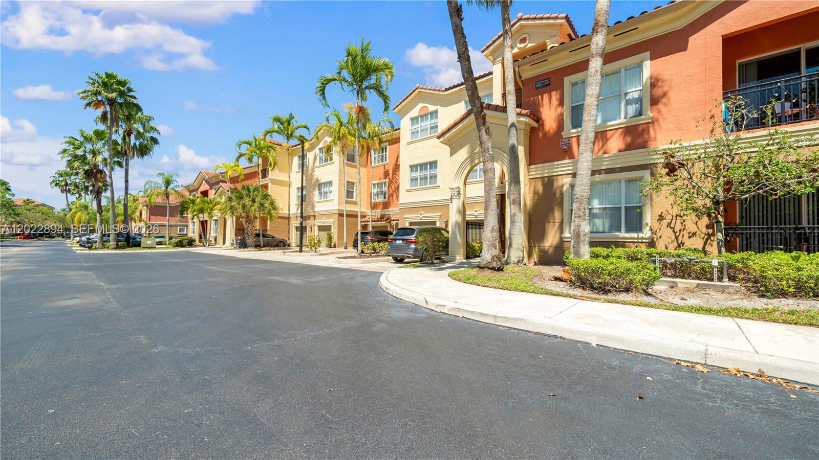 A multi-story apartment building with stucco walls, palm trees, and a paved parking lot — 4400 SW 160th Ave # 1015, Miramar FL 33027, MIRAMAR, FL