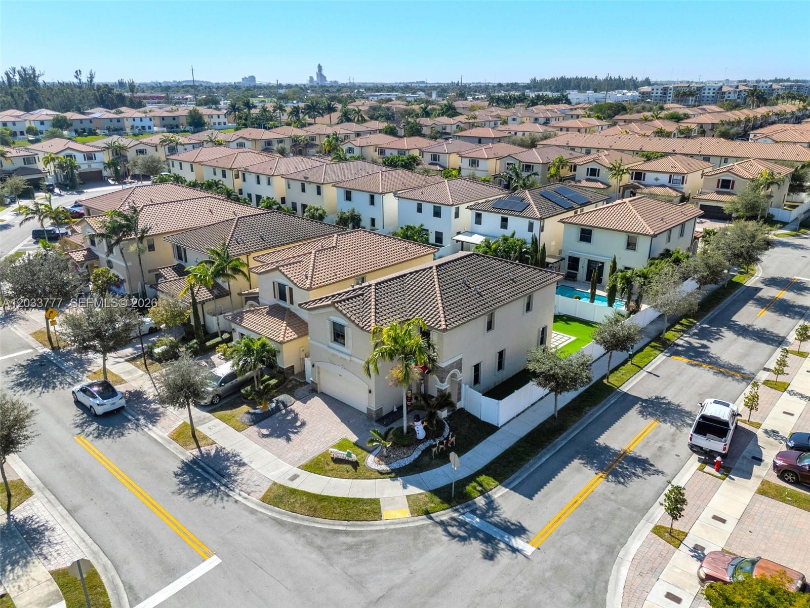 An aerial view shows a suburban neighborhood with two-story houses, tiled roofs, and paved streets — 8894 W 34th Ave, Hialeah FL 33018, HIALEAH, FL