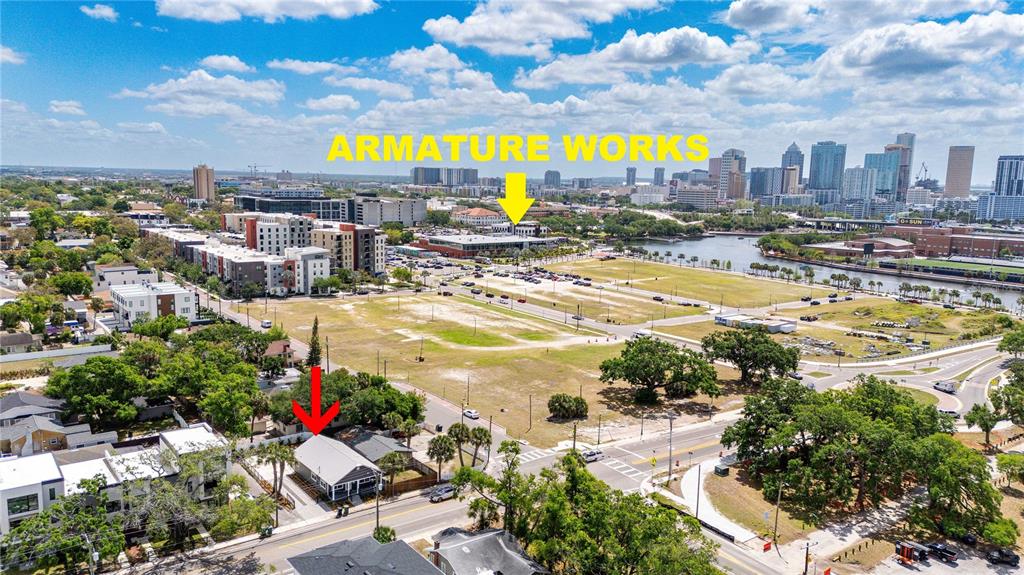An aerial view shows a small house in the foreground with a large urban development — 2203 N BOULEVARD, TAMPA, FL