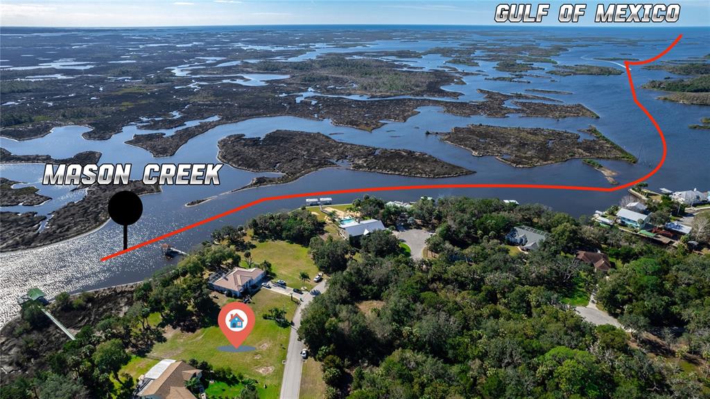 This aerial view shows a waterfront property along Mason Creek leading to the Gulf of Mexico — 12214 W RESTVIEW COURT, HOMOSASSA, FL