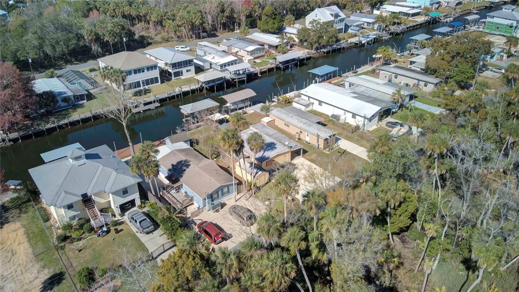 An aerial view of waterfront homes along a canal with docks and surrounding palm trees — 2630 N COMANCHE POINT, CRYSTAL RIVER, FL