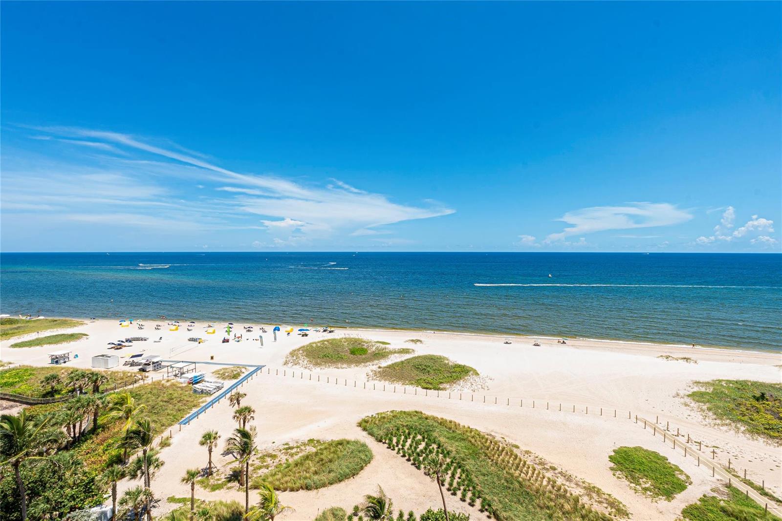 An elevated view of a sandy beach with dunes, palm trees, and the ocean — 1116 N Ocean Boulevard # 904, Pompano Beach FL 33062, POMPANO BEACH, FL