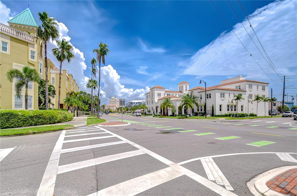 A street view shows a crosswalk leading toward Mediterranean-style buildings under a bright blue sky — 113 BOSPHOROUS AVENUE UNIT 5, TAMPA, FL