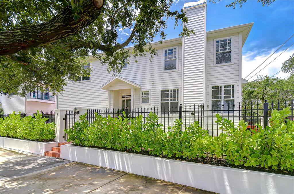 A two-story white house with a black metal fence and a hedge in the front — 113 BOSPHOROUS AVENUE UNIT 5, TAMPA, FL