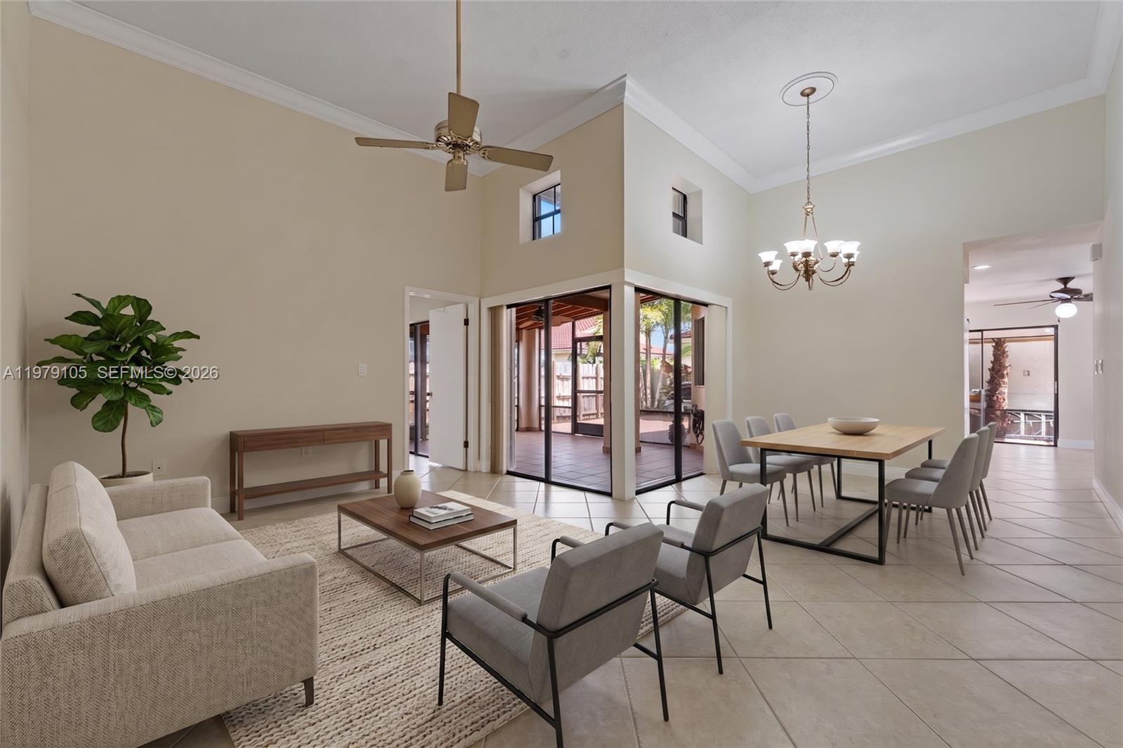 A bright, open-concept living and dining area features tile floors, high ceilings, and glass doors — 536 SW 88th Ct, Miami FL 33174, MIAMI, FL