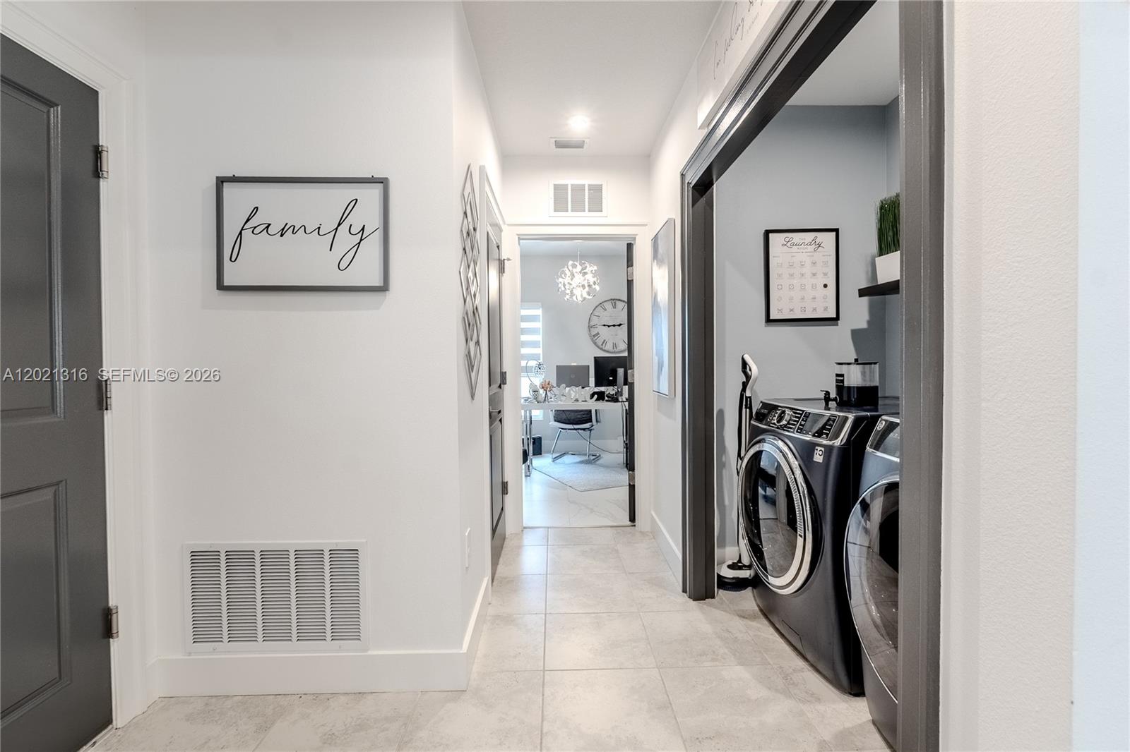 A hallway leads to an office, with a laundry room on the right — 215 Raspberry Rd, Fort Pierce FL 34981, FORT PIERCE, FL