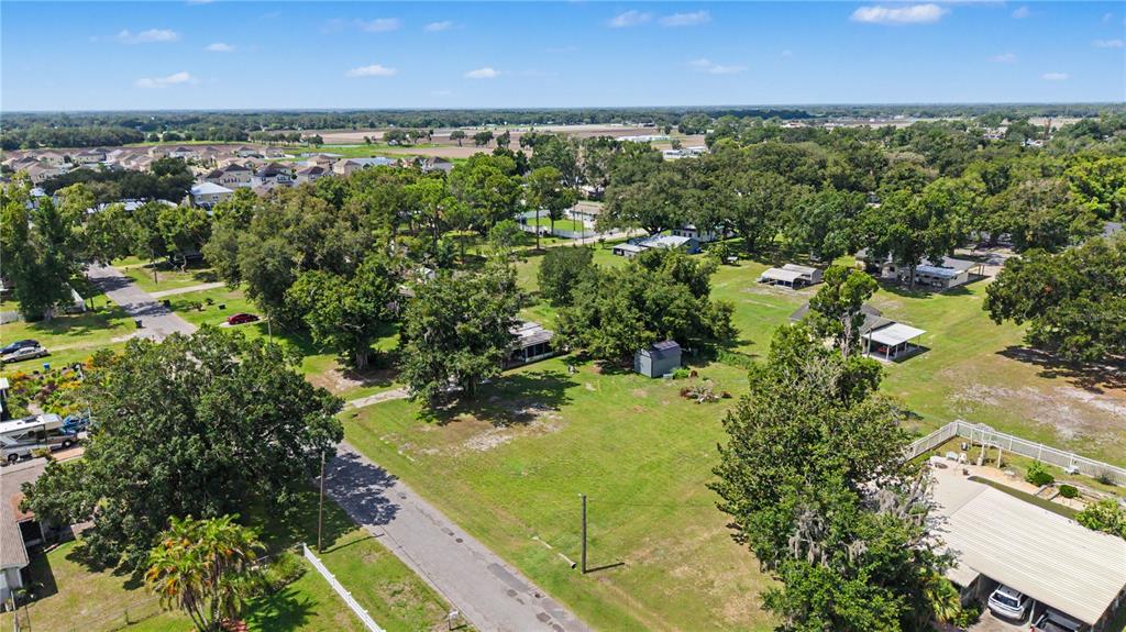 An aerial view shows a residential lot with trees, a small shed, and surrounding houses — 3015 DER ROAD, PLANT CITY, FL