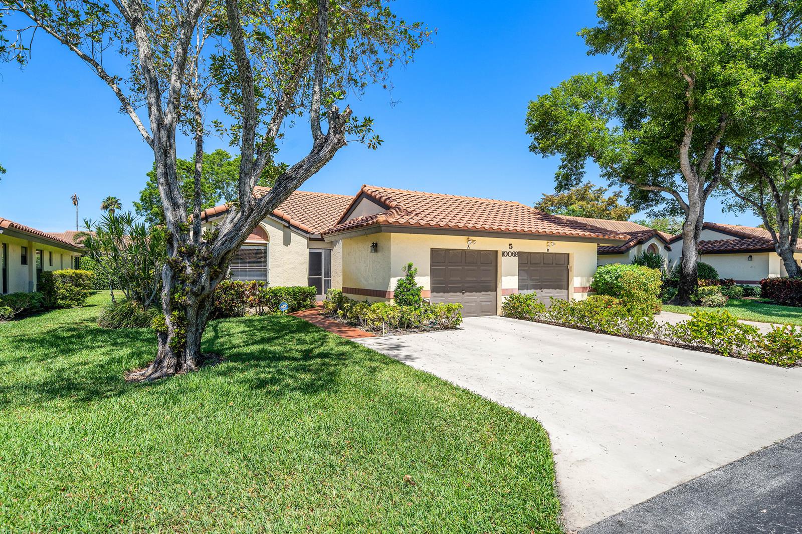 A single-story house with a two-car garage, tile roof, and a front lawn with trees — 10069 Andrea Lane # A, Boynton Beach FL 33437, BOYNTON BEACH, FL