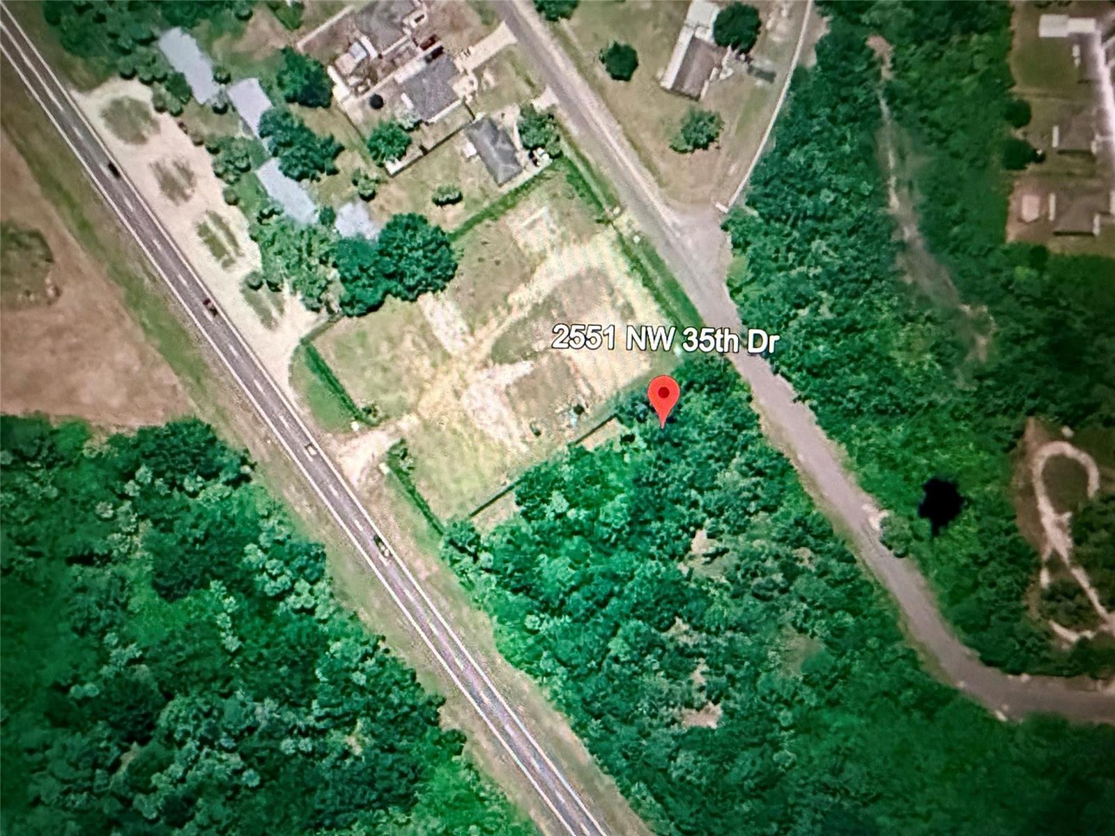 This is an aerial map view of a vacant, partially wooded residential lot — 2551 NW 35th Drive, Okeechobee FL 34972, OKEECHOBEE, FL
