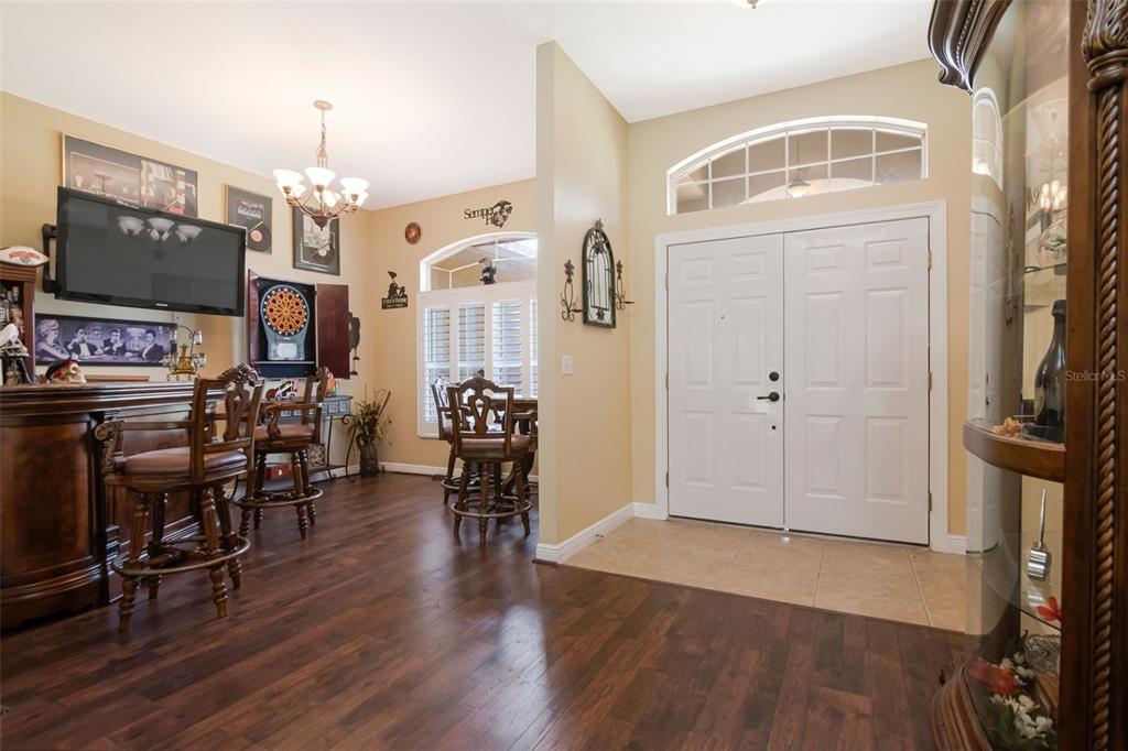 A home entryway features a tiled floor, double front doors, and an adjacent bar area — 3823 ANCIENT OAK TRAIL, PLANT CITY, FL