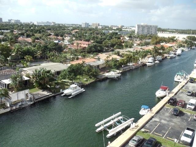 An elevated view shows a canal with several docked boats and a nearby parking lot — 2020 NE 135th St # 904, North Miami FL 33181, NORTH MIAMI, FL