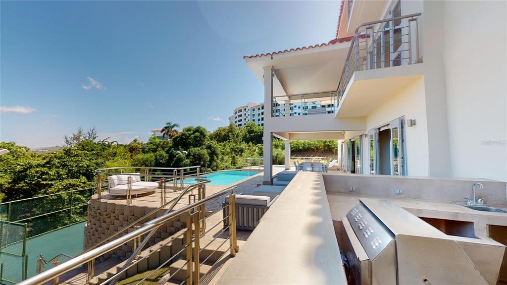 An outdoor patio features a built-in grill, a swimming pool, and a multi-level balcony — 52 LAS VISTAS DE RIO MAR, RIO GRANDE, PR