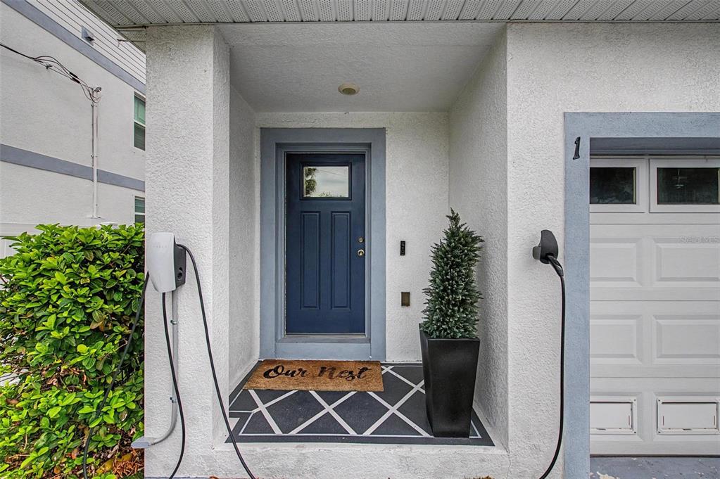 A front entryway features a blue door, a Tesla wall charger, and a patterned floor — 6023 INTERBAY BOULEVARD UNIT 1, TAMPA, FL