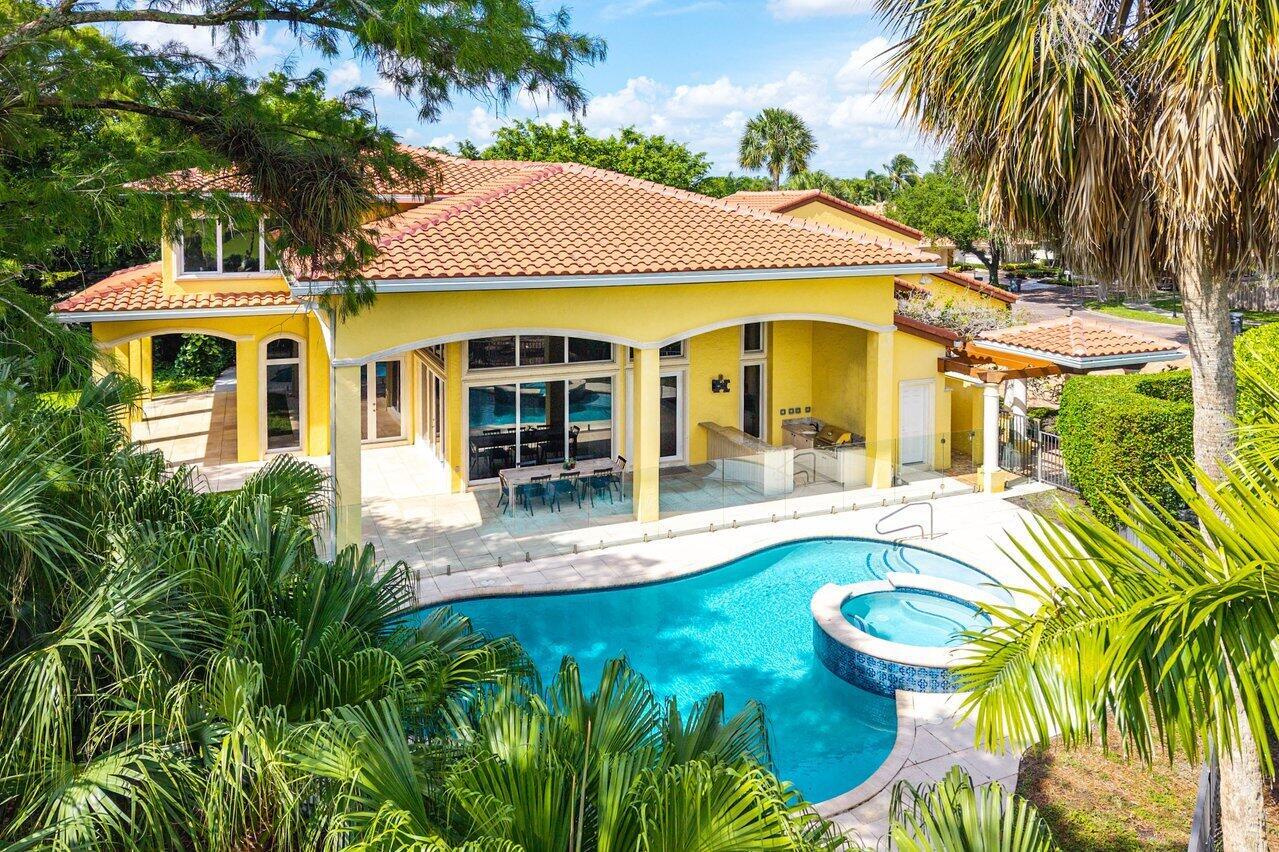 An aerial view of a yellow house with a tiled roof, pool, and patio area — 6541 Timber Lane, Boca Raton FL 33433, BOCA RATON, FL