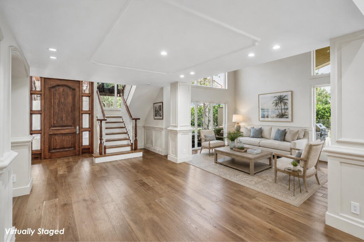 A living room with hardwood floors, a wooden staircase, and a sofa set — 6541 Timber Lane, Boca Raton FL 33433, BOCA RATON, FL