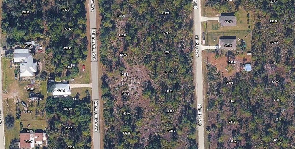 This aerial map shows residential lots and undeveloped land along two parallel paved roads — 12297 and 12303 HINDLE AVENUE, PUNTA GORDA, FL