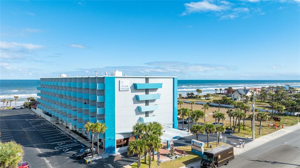 An aerial view shows a multi-story blue and white hotel building near the ocean — 313 S ATLANTIC AVENUE UNIT 2260, DAYTONA BEACH, FL
